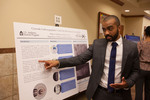 Honors Scholar Philip Giddings explains his poster "Cytosolic Carboxypeptidase 5 (CCP5) and Cilia Development in Zebrafish" by Andrews University
