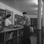 [Student at the circulation desk of Emmanuel Missionary College library] by James White Library