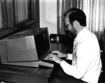 [Harvey Brenneise working on a computer in the James White Library] by James White Library